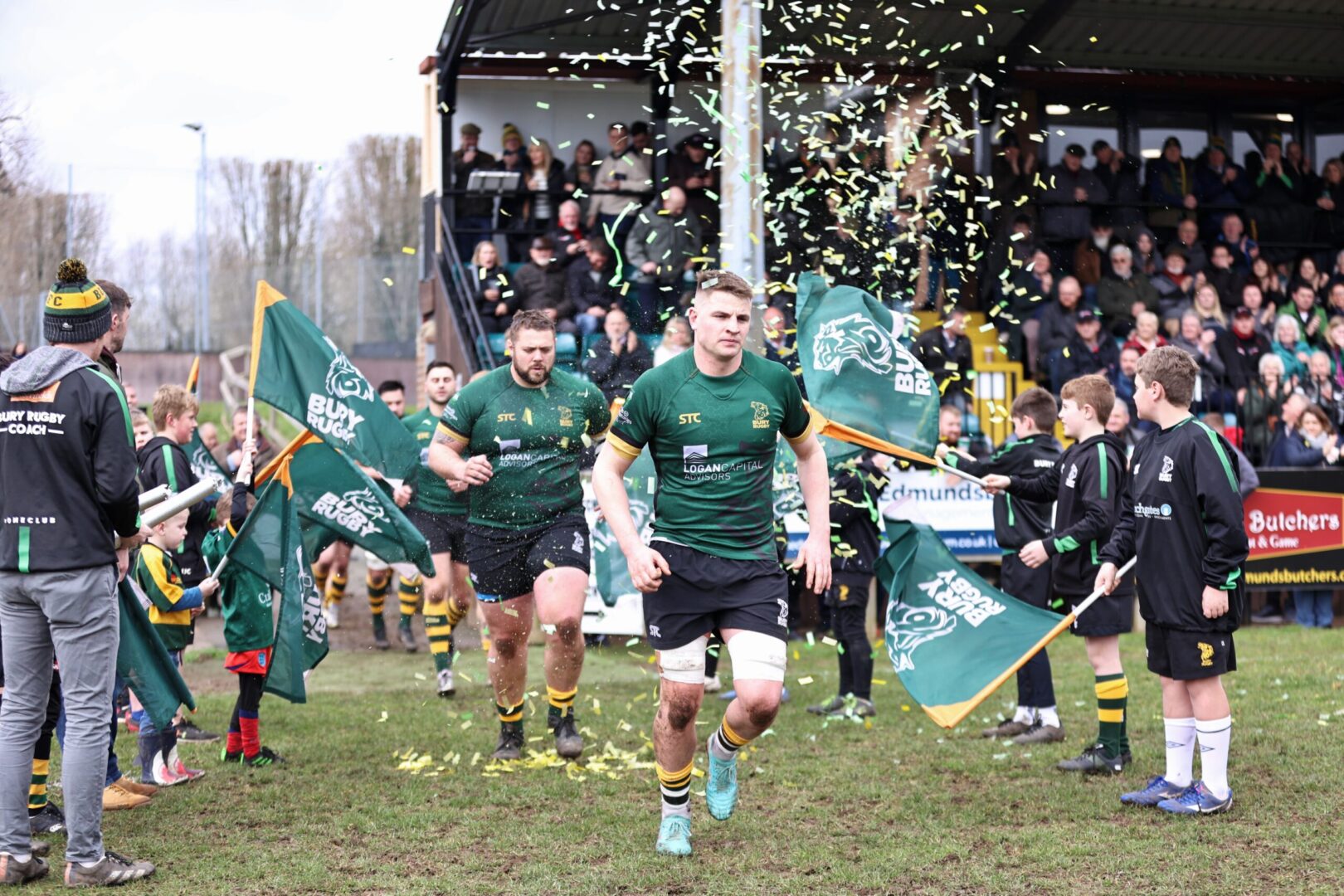 Rugby players running onto the pitch